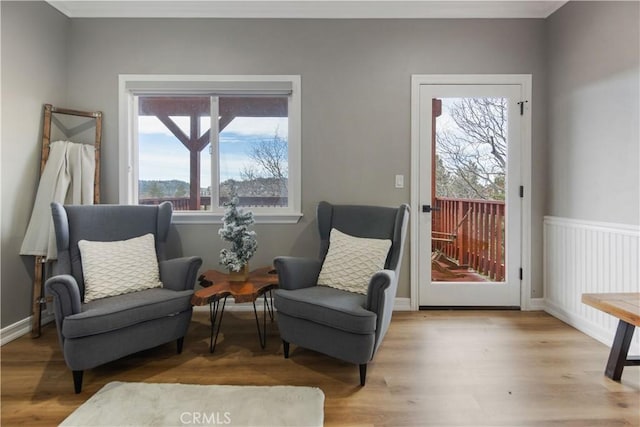 living area with wood finished floors and baseboards