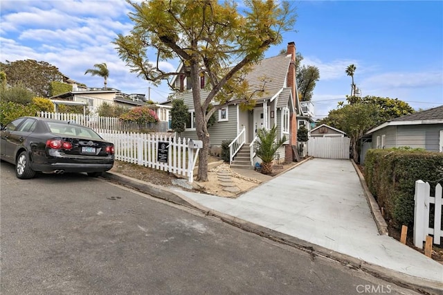 view of front of house featuring a fenced front yard and a gate