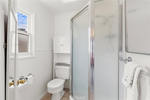 full bathroom featuring a shower stall, toilet, and tile patterned floors