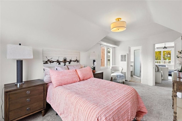 bedroom with vaulted ceiling and carpet floors