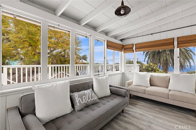 sunroom with lofted ceiling with beams