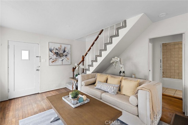 living area with stairs and hardwood / wood-style floors