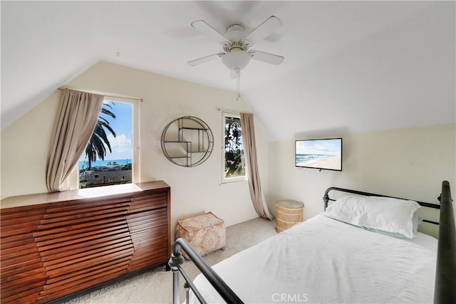 carpeted bedroom featuring lofted ceiling, ceiling fan, and multiple windows