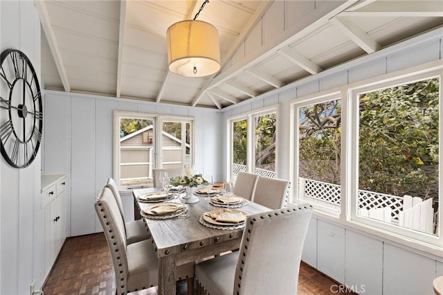 sunroom / solarium with vaulted ceiling with beams