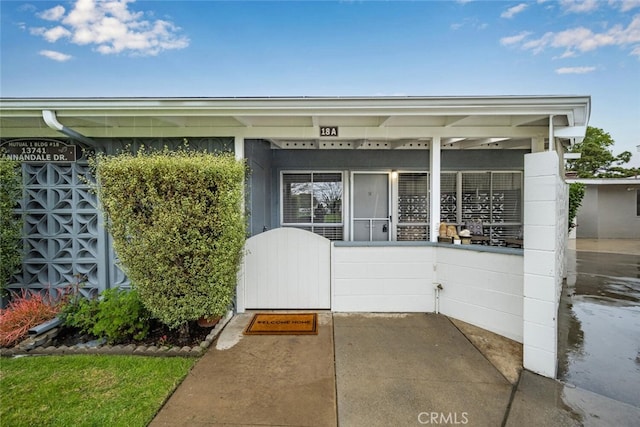 view of exterior entry featuring concrete block siding