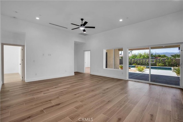 unfurnished living room with recessed lighting, visible vents, light wood-style flooring, ceiling fan, and baseboards