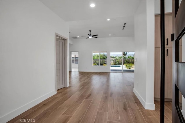 interior space featuring light wood-style floors, recessed lighting, and baseboards