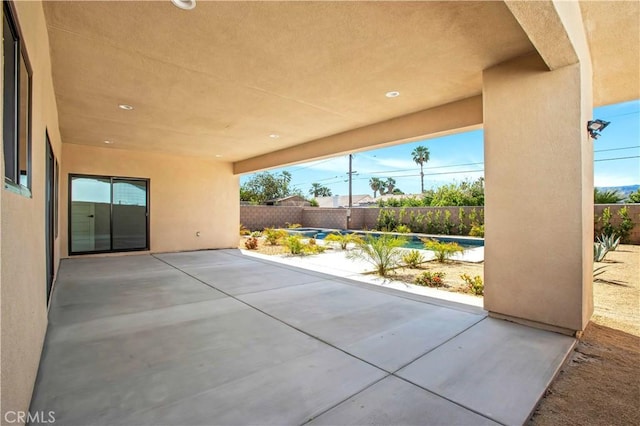 view of patio with a pool and a fenced backyard