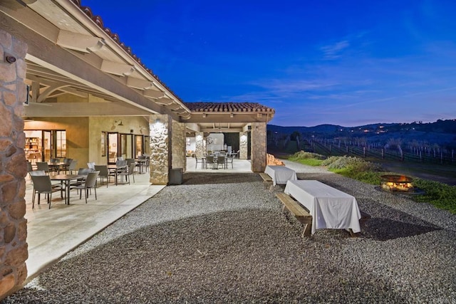 view of patio / terrace featuring outdoor dining area and a fire pit