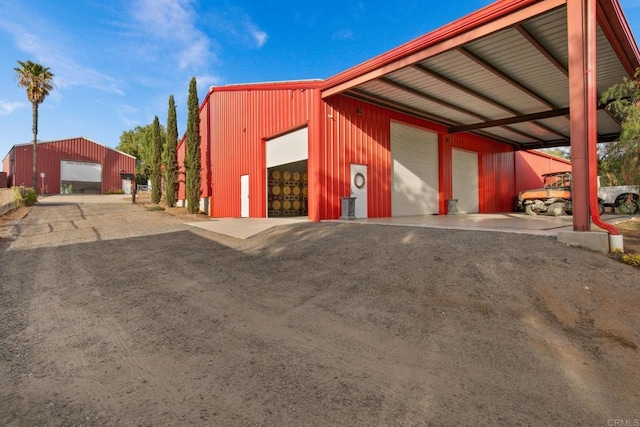 exterior space with an outbuilding and a detached garage