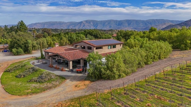 exterior space featuring a forest view and a mountain view