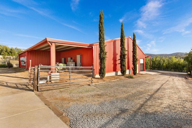 view of front of property featuring an exterior structure and an outbuilding