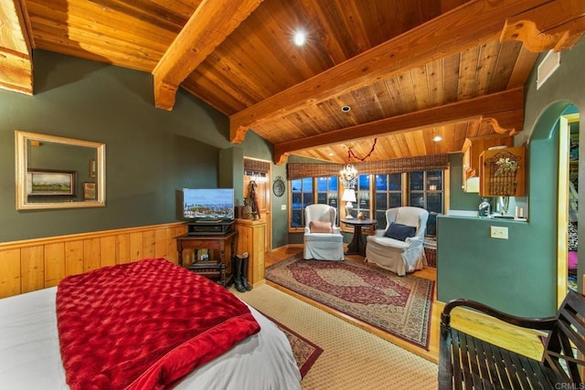 carpeted bedroom with a wainscoted wall, vaulted ceiling with beams, wood ceiling, wood walls, and a chandelier