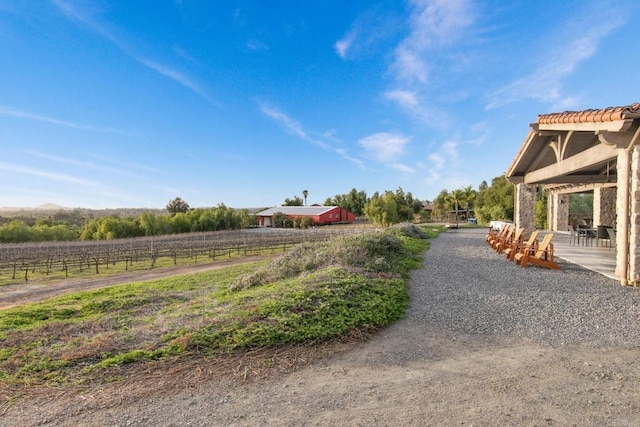 view of yard with a rural view and fence