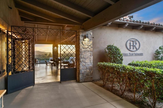 patio terrace at dusk featuring outdoor dining area