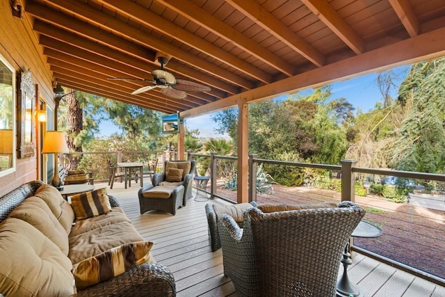 wooden terrace featuring ceiling fan and an outdoor living space