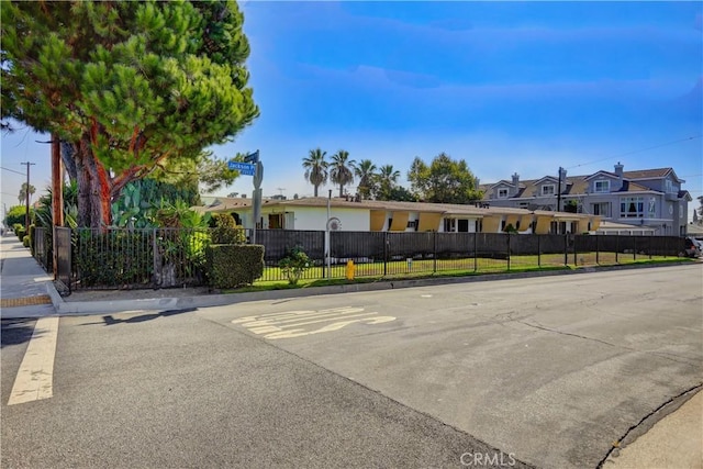 view of front of home featuring fence and a residential view