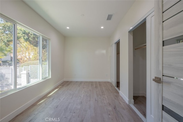 unfurnished bedroom featuring recessed lighting, visible vents, light wood-style flooring, and baseboards