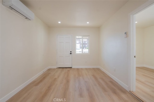 foyer with light wood-type flooring, recessed lighting, baseboards, and a wall mounted AC