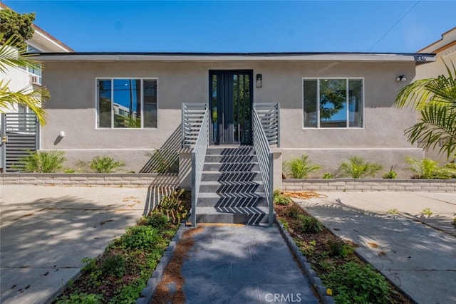 view of front of house featuring stucco siding