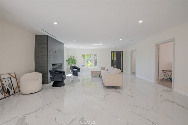 living area with baseboards, marble finish floor, a fireplace, and recessed lighting