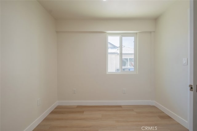 unfurnished room featuring light wood-style floors and baseboards