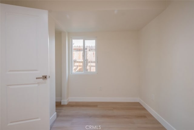 unfurnished room featuring light wood-style floors and baseboards