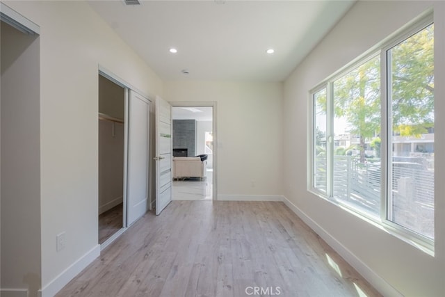 interior space with light wood finished floors, recessed lighting, a closet, visible vents, and baseboards