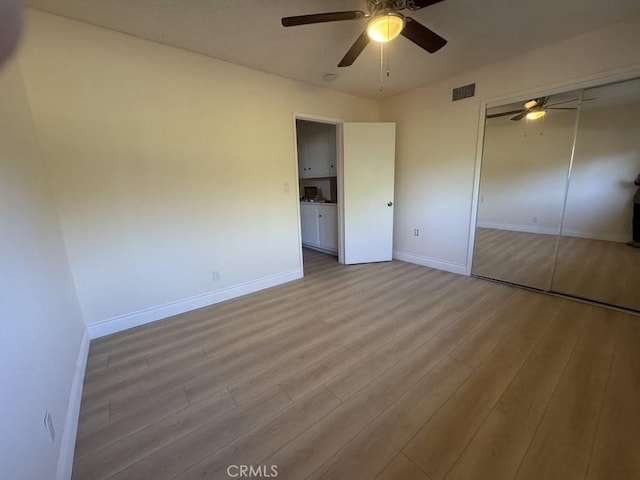 unfurnished bedroom with baseboards, visible vents, ceiling fan, and light wood finished floors