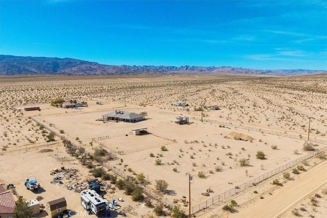 drone / aerial view featuring a rural view, a mountain view, and view of desert