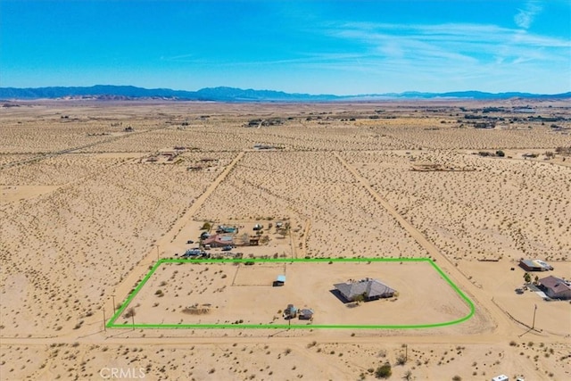 birds eye view of property with a rural view, a mountain view, and view of desert