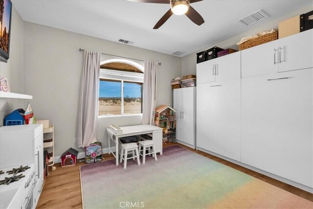 game room featuring light wood-style floors, visible vents, and ceiling fan