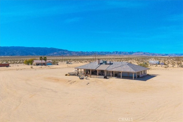 property view of mountains featuring a rural view and a desert view