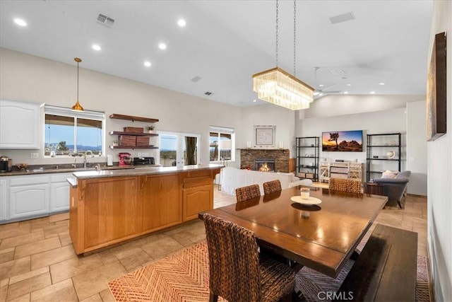 dining area with high vaulted ceiling, recessed lighting, visible vents, and a fireplace