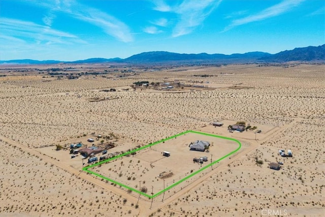 birds eye view of property featuring a mountain view, a desert view, and a rural view