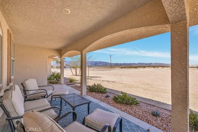 view of patio featuring a mountain view and an outdoor hangout area