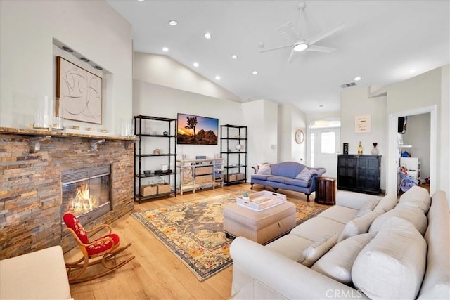 living area with a fireplace, recessed lighting, visible vents, ceiling fan, and wood finished floors