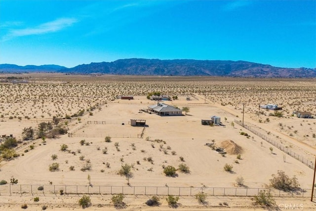 property view of mountains featuring view of desert and a rural view