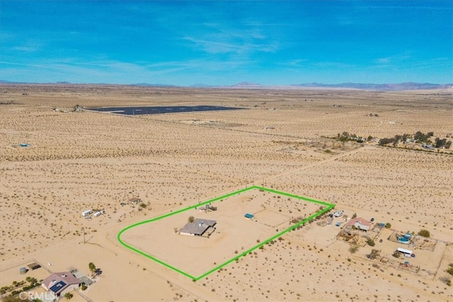 birds eye view of property with view of desert, a rural view, and a mountain view