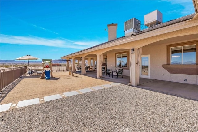 exterior space with central AC and fence