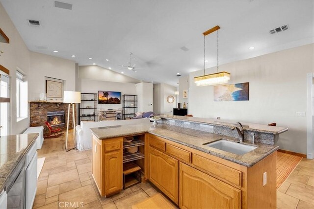 kitchen featuring open floor plan, a sink, and visible vents