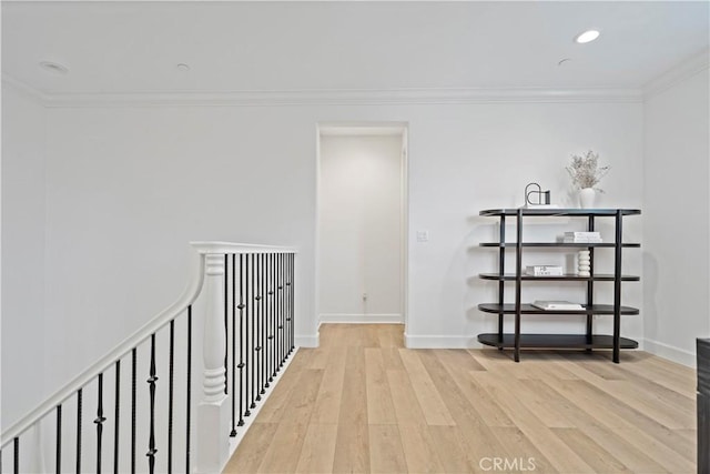 hall with baseboards, ornamental molding, wood finished floors, and recessed lighting