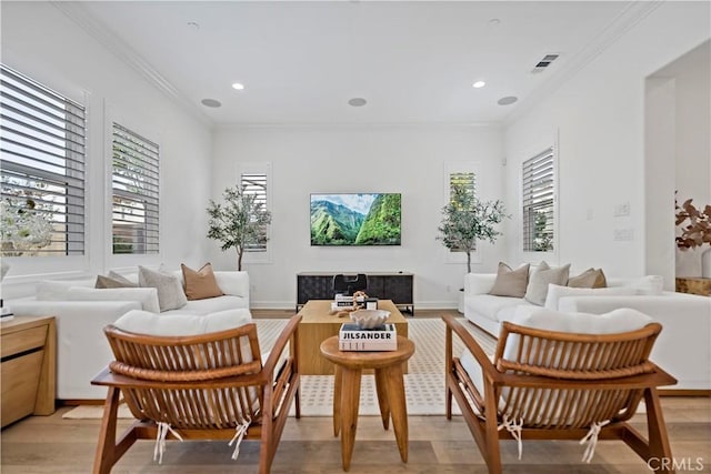 sitting room featuring ornamental molding, light wood-style floors, plenty of natural light, and recessed lighting