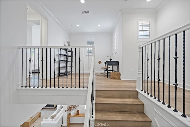 stairs featuring recessed lighting, wood finished floors, visible vents, and crown molding