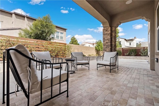 view of patio featuring fence and an outdoor living space