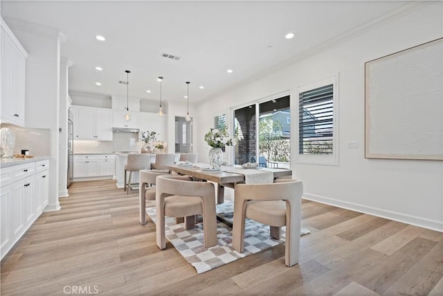 dining area with ornamental molding, recessed lighting, visible vents, and light wood-style floors