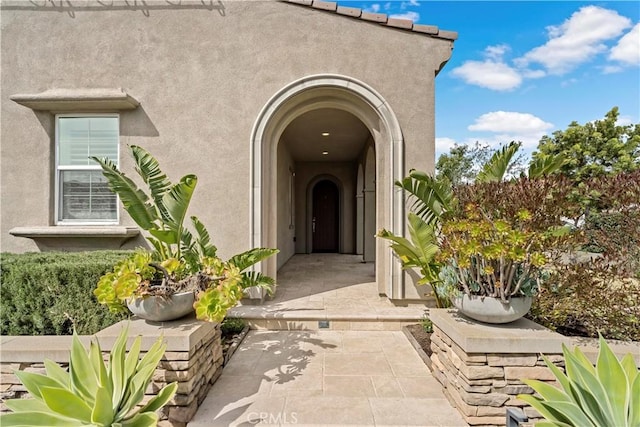 view of exterior entry with stucco siding