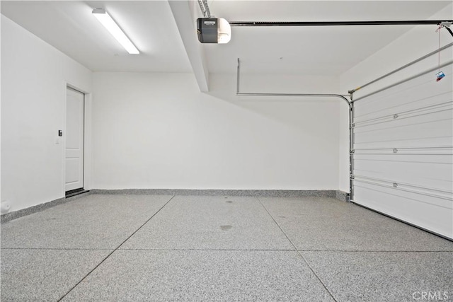 garage featuring baseboards and a garage door opener