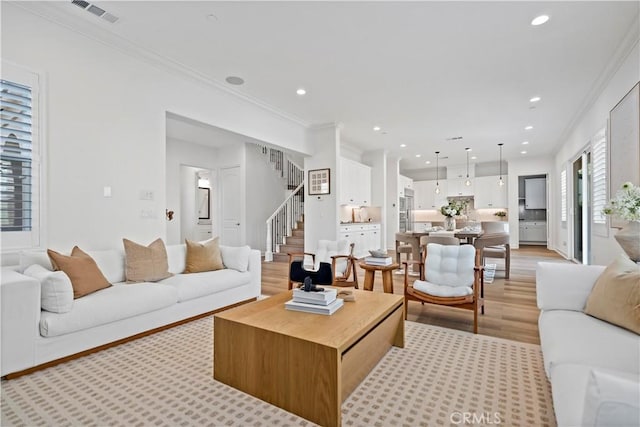 living room featuring stairway, recessed lighting, visible vents, and crown molding