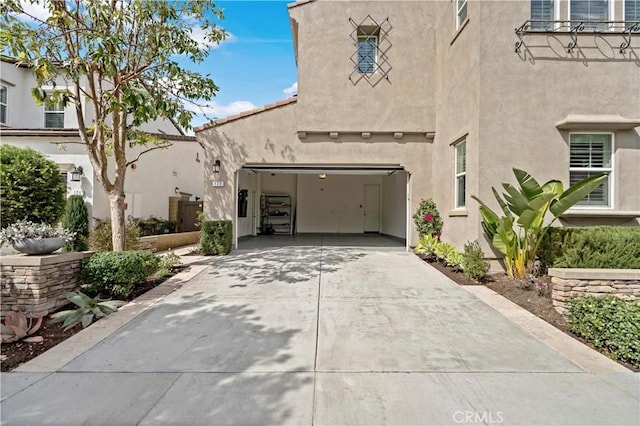 view of front facade with concrete driveway and stucco siding